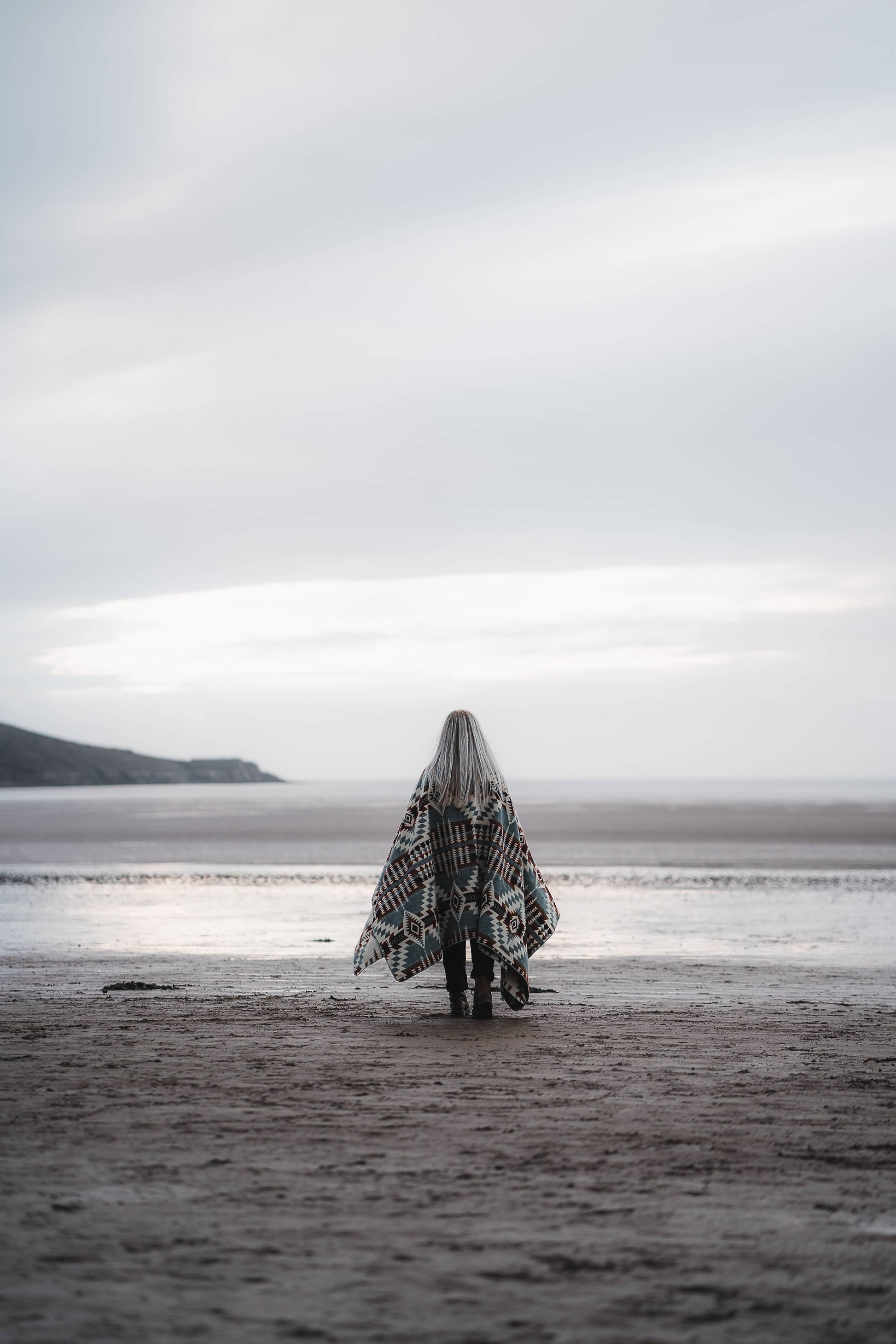 Person walking by ocean in Secoya Blanket by belle aura