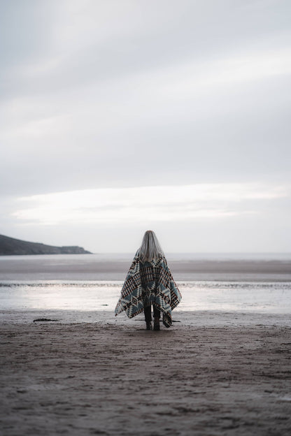 Person walking by ocean in Secoya Blanket by belle aura