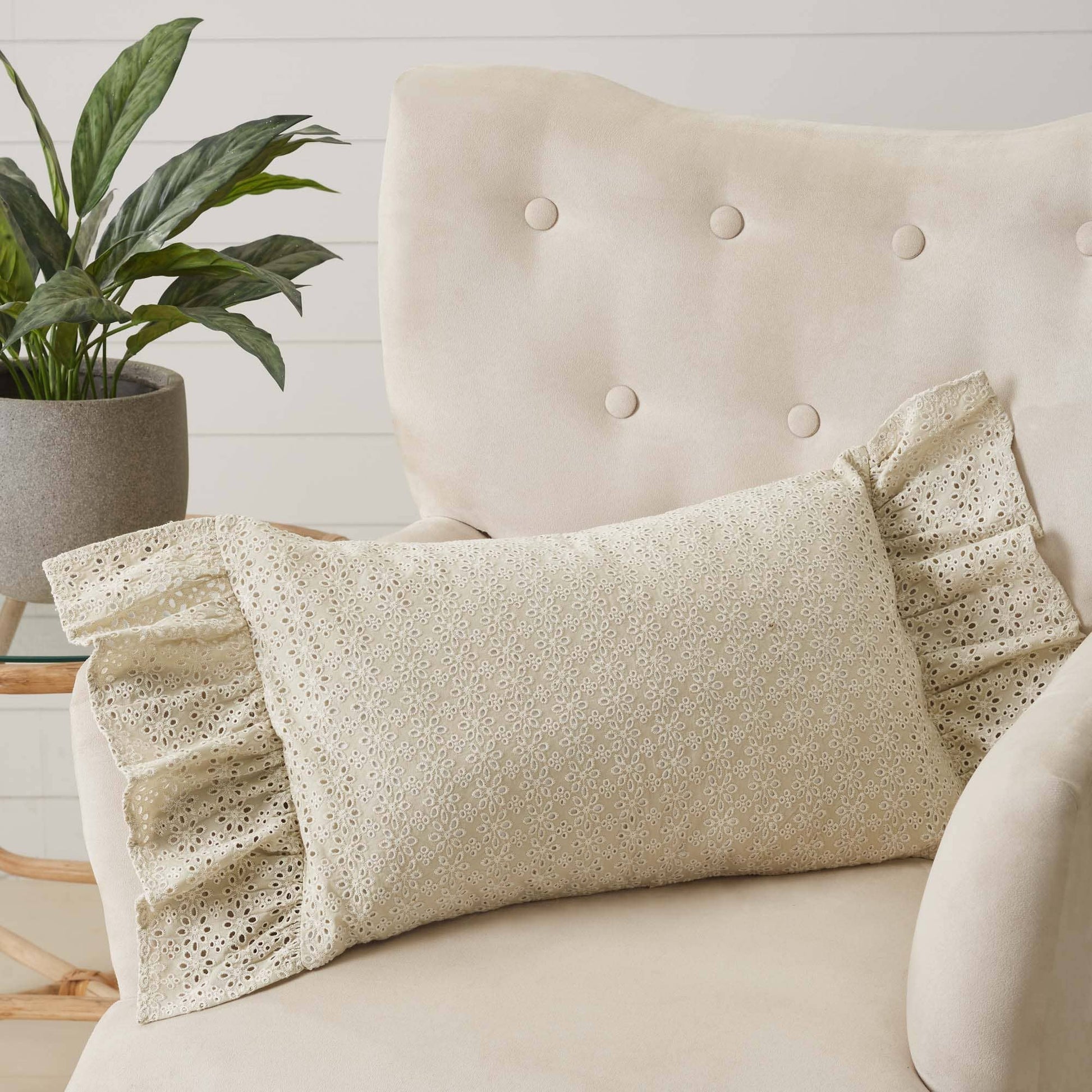 Camilia Eyelet Pillow By Belle Aura On Cozy Beige Chair With Ruffled Edges