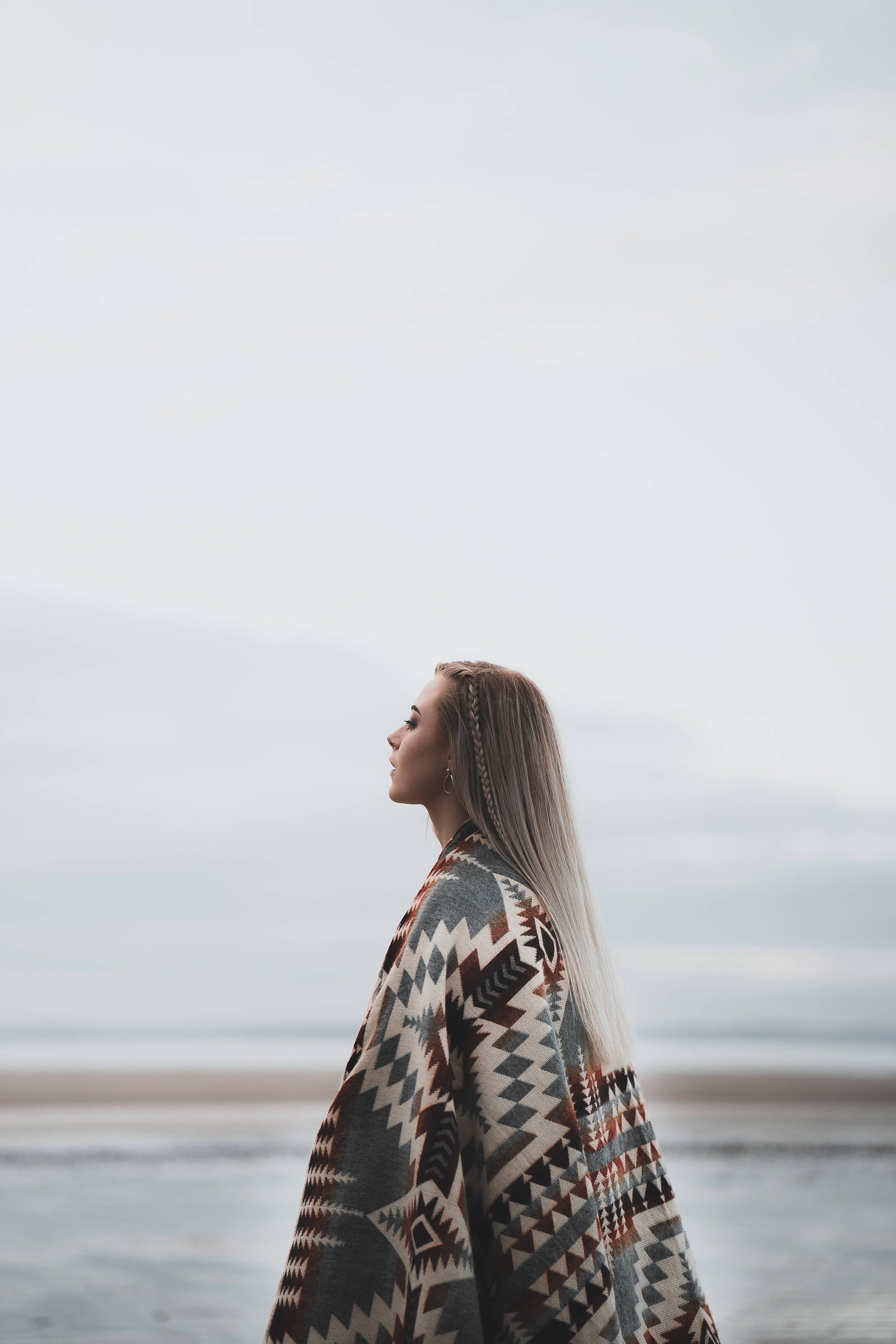 Woman gazing at sea in Secoya Blanket by belle aura