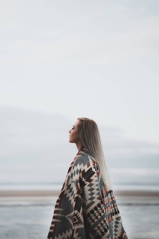 Woman gazing at sea in Secoya Blanket by belle aura