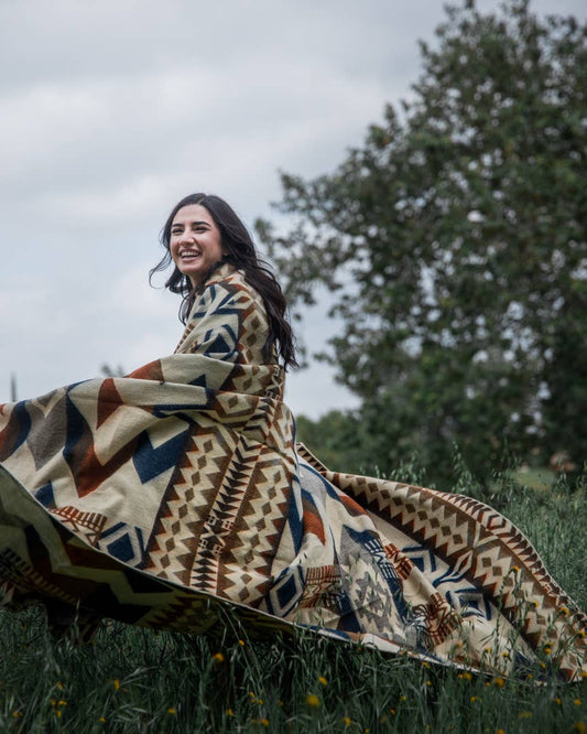 Awa Blanket Draped in Open Field by Belle Aura