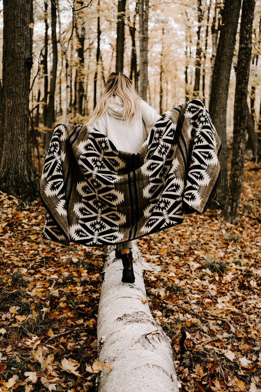 Woman Walking in Forest Wearing Quichua Blanket by Belle Aura