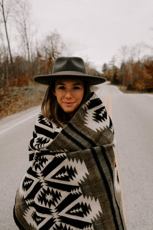 Stylish Woman Posing Outdoors in Quichua Blanket by Belle Aura