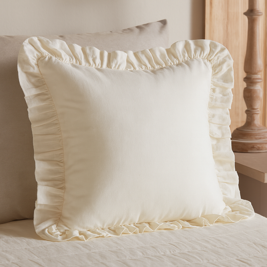 Styled Elizabeth Ruffled Euro Sham on a beige chair in soft lighting by belle aura