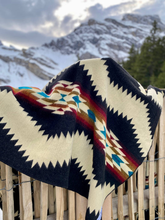 Close-Up Of Black And Beige Geometric Patterned Blanket Hanging Outdoors By Bella Aura