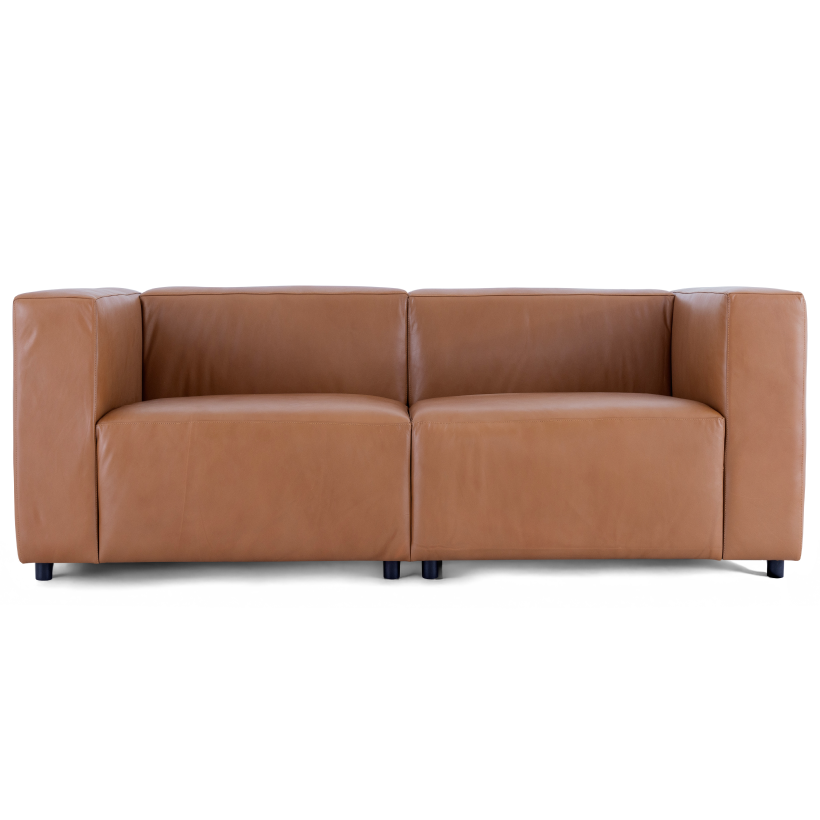 A straight-on view of the Aaran sofa in cognac top grain leather, showing its modern boxy design and deep seats.