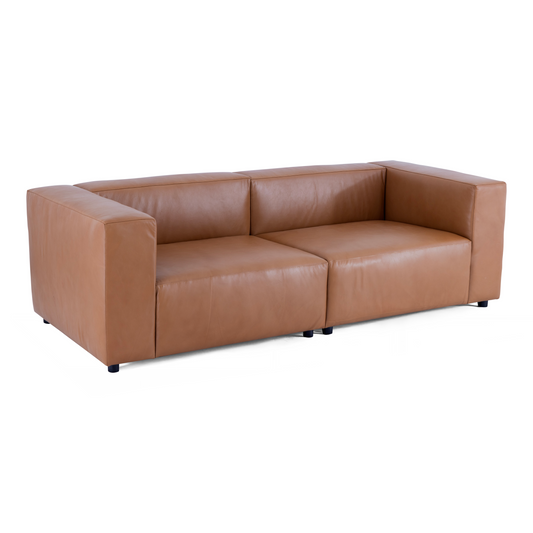 An angled perspective of the Aaran leather sofa highlighting its deep seating and low-profile minimalist frame.