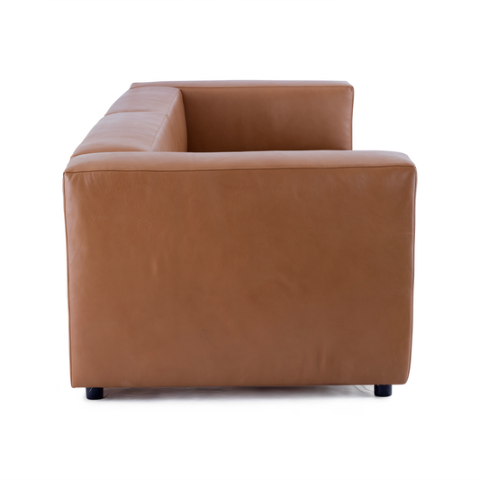A side profile of the Aaran sofa showing the substantial thickness of the leather arms and the clean back design.