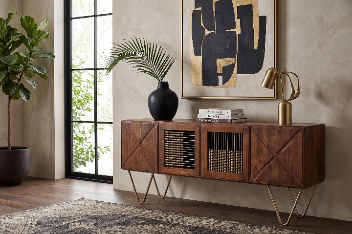 The warm walnut Aurelia Sideboard used as a luxury media console, styled with a brass lamp, palm vase, and mid-century modern art.