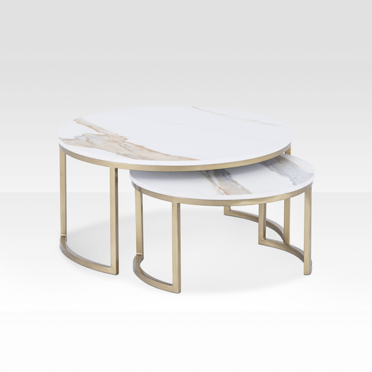 A pair of Concord nesting coffee tables with solid white marble tops and brushed gold frames, featuring an organic cloud-shaped silhouette.