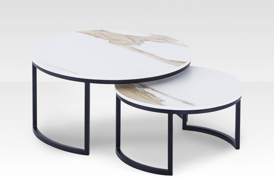 The Concord solid marble nesting tables in a black finish spread apart, highlighting the authentic stone veining and dynamic beveled edges.