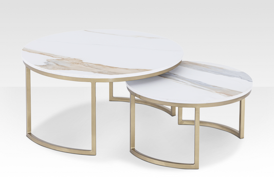 The Concord solid marble nesting tables spread apart to showcase the natural stone veining and the elegant beveled edges in a gold finish.