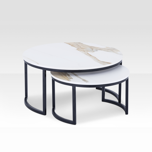 A pair of Concord nesting coffee tables in black and solid white marble, featuring an organic cloud-shaped silhouette and space-saving design.