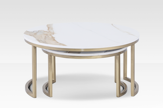 A pair of Concord nesting coffee tables with solid white marble cloud-shaped tops and a brushed gold architectural C-base.