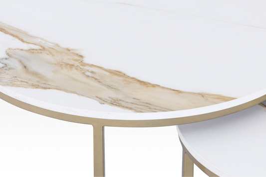 An angled view of the individual large Concord coffee table, showcasing the substantial thickness of the solid marble top and the gold C-base.