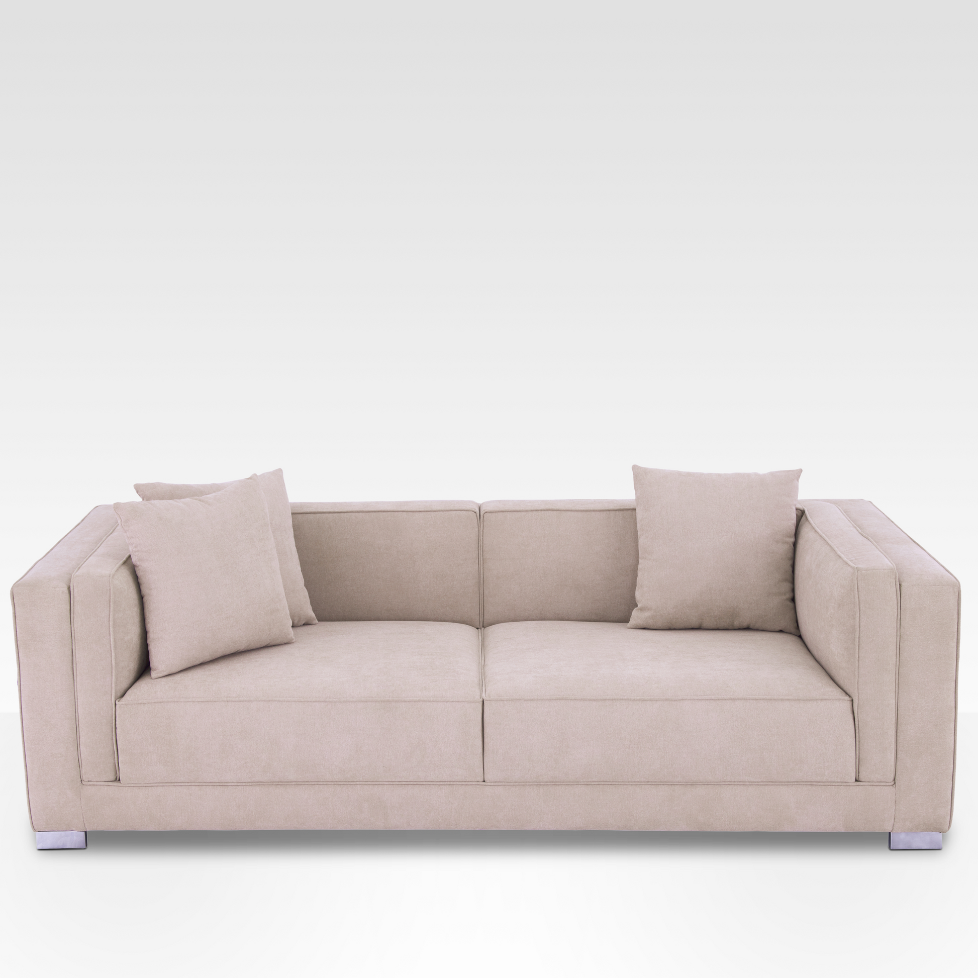 An angled perspective of the Elysian sofa in Seaside Sand, highlighting the deep seating and modern block silhouette.