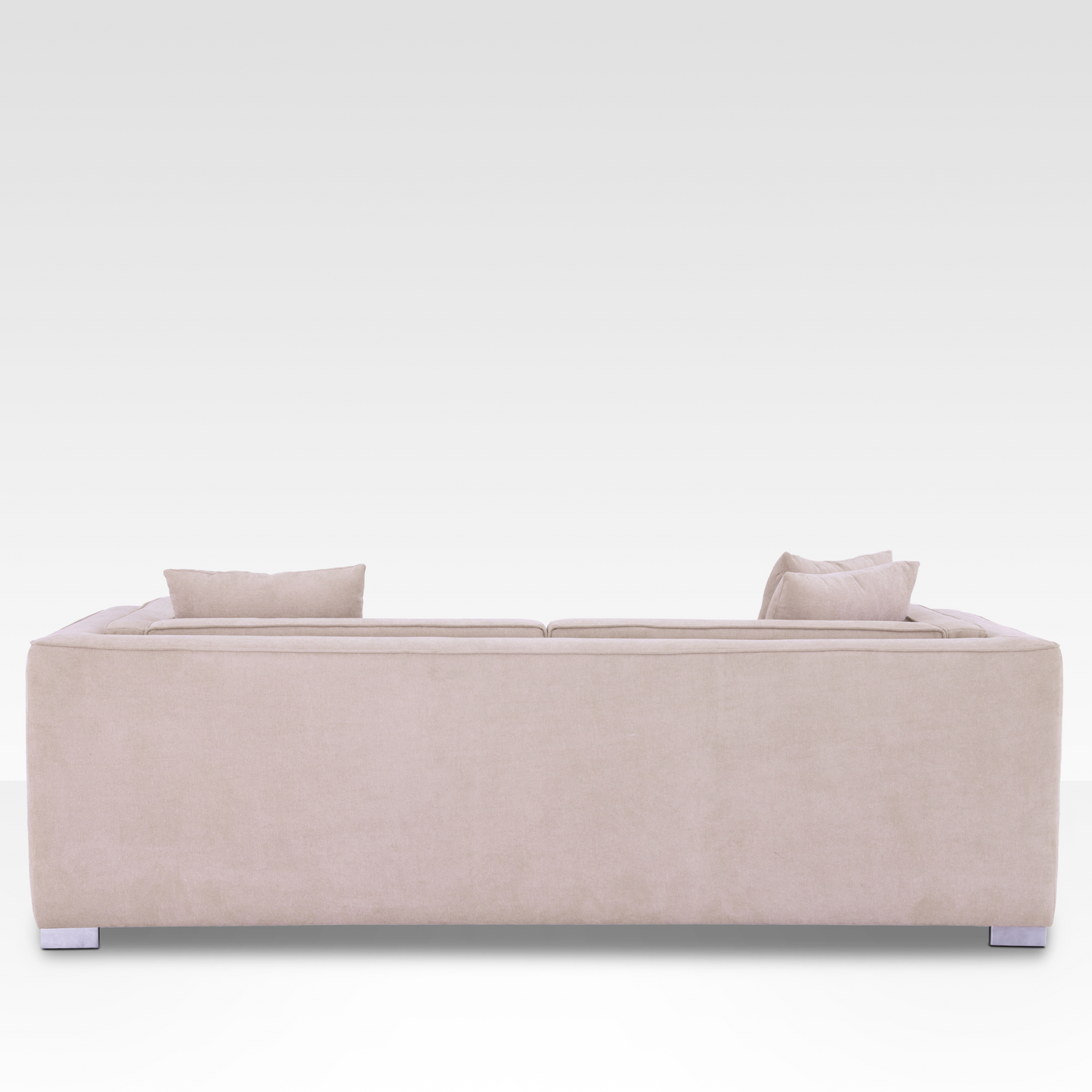 sofa, showing the continuous Seaside Sand fabric wrap and modern polished chrome legs.