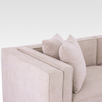 A close-up of the Elysian sofa's unique inset track arm and textured Seaside Sand upholstery.