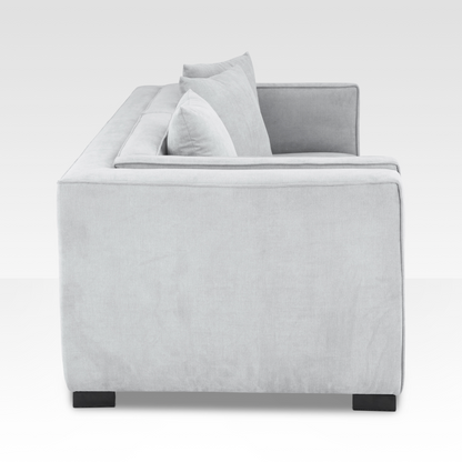 A side profile of the Elysian sofa showing the deep geometric frame and the low-profile dark steel legs.