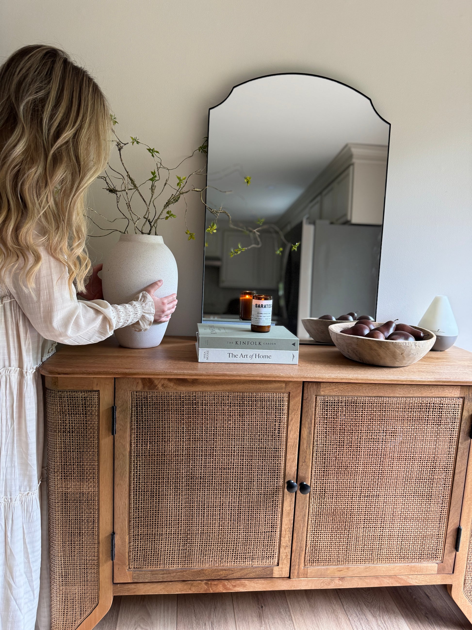The Filigree Sideboard utilized as a coastal-inspired dining room buffet styled with artisanal ceramics.
