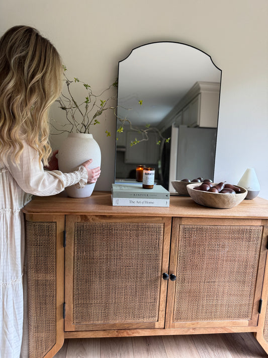 The Filigree Sideboard utilized as a coastal-inspired dining room buffet styled with artisanal ceramics.
