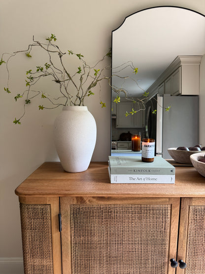 Close-up detail of the intricate hand-woven natural cane mesh and smooth mango wood frame on the Filigree Sideboard.