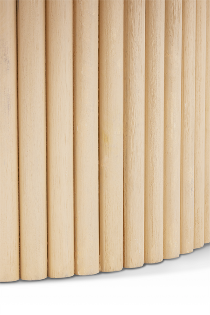 Macro close-up of the Grove Coffee Table base, showing the individual vertical wood rods and handcrafted fluted texture.