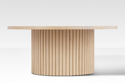 Straight-on profile of the Grove Coffee Table highlighting the rhythmic vertical rods of the fluted pedestal base.