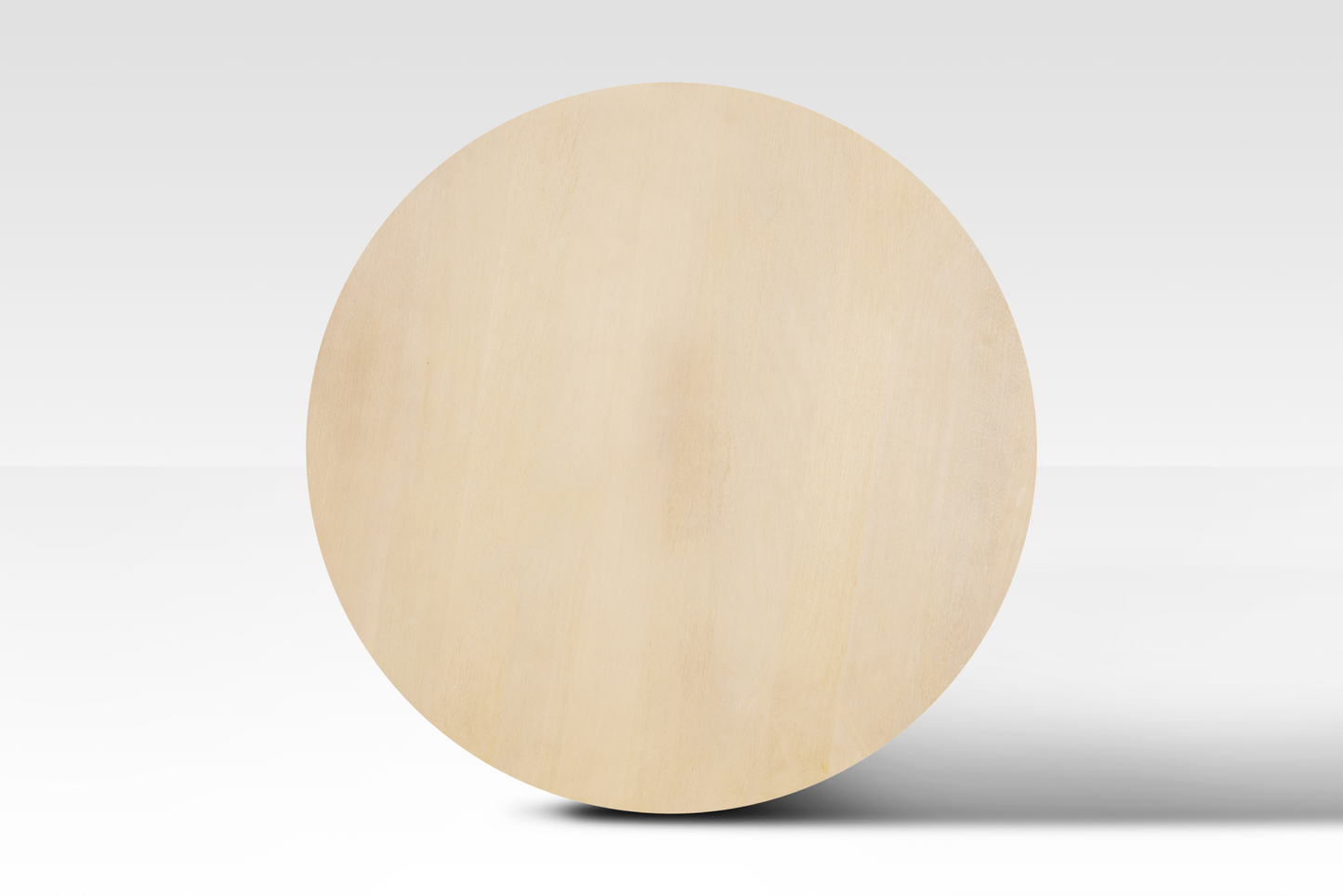 A perfectly circular overhead view of the Grove Coffee Table in natural wood, showcasing its smooth minimalist surface and organic grain.