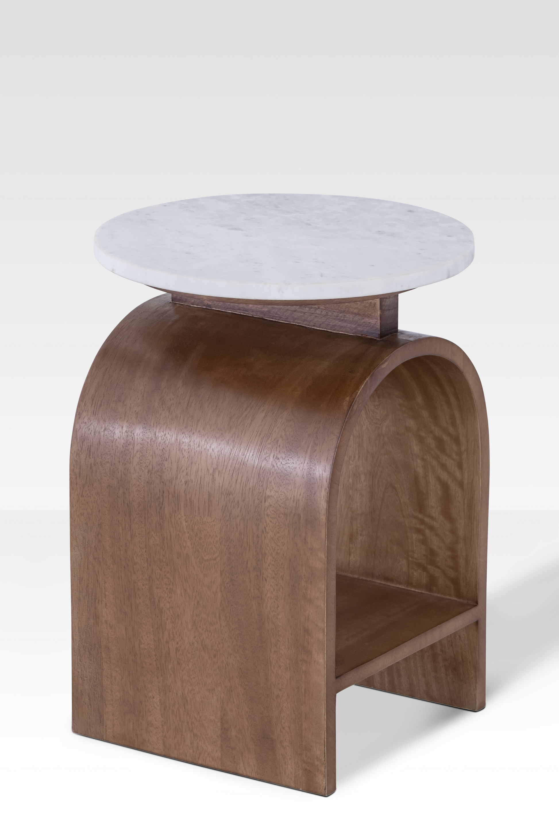Rear perspective of the Kromme End Table showing the integrated walnut shelf and the substantial architectural support of the curved base.