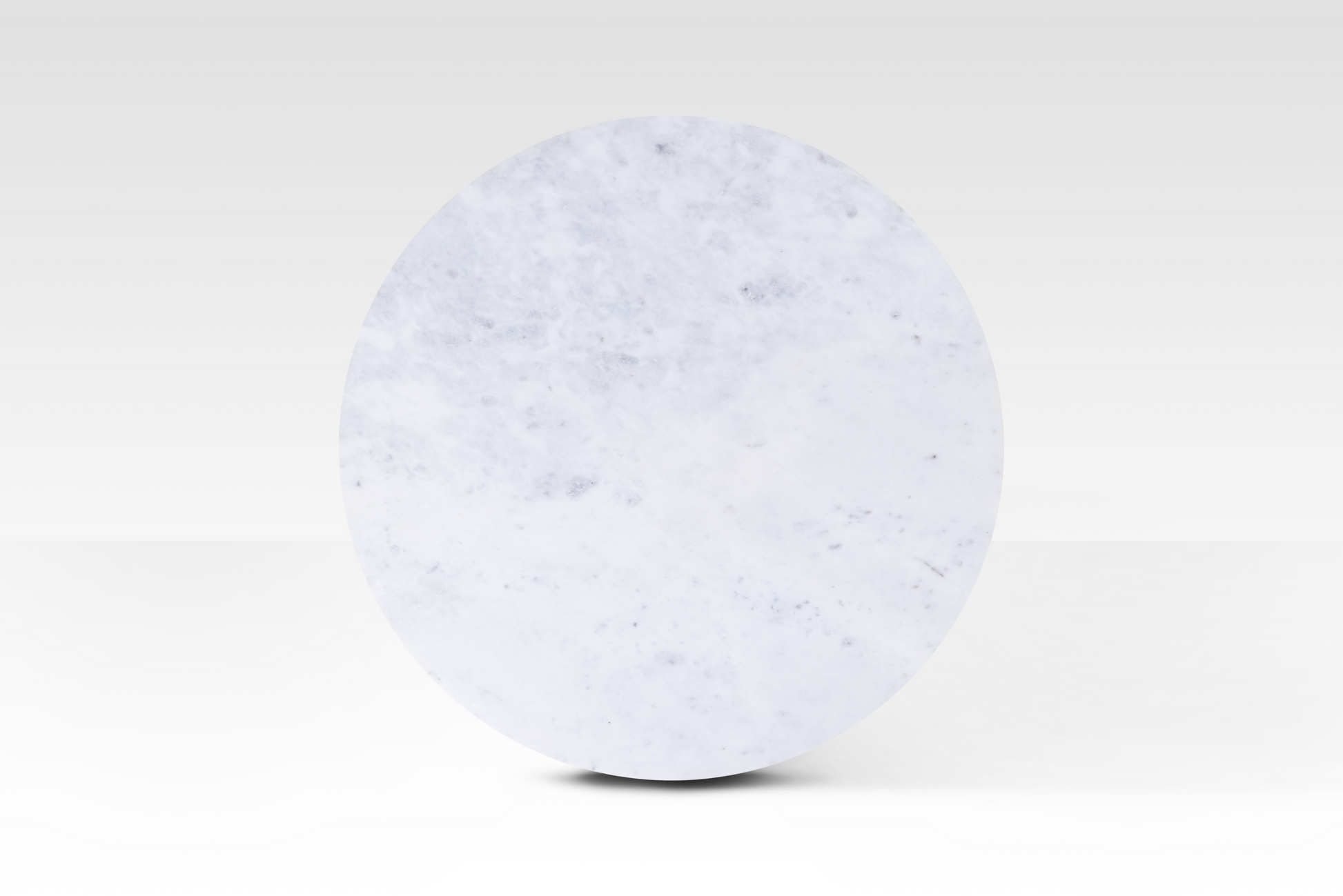 A perfectly circular overhead view of the Kromme End Table, showcasing the natural grey veining and polished surface of the solid white marble top.