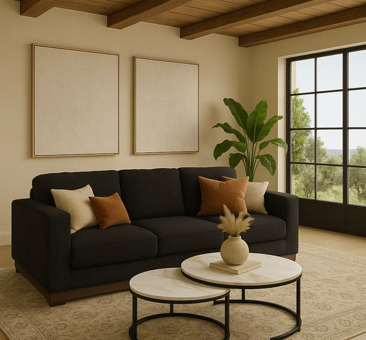 The Kyra sofa in Pewter gray fabric paired with the Concord nesting coffee tables with marble tops and black legs in a warm modern living room.