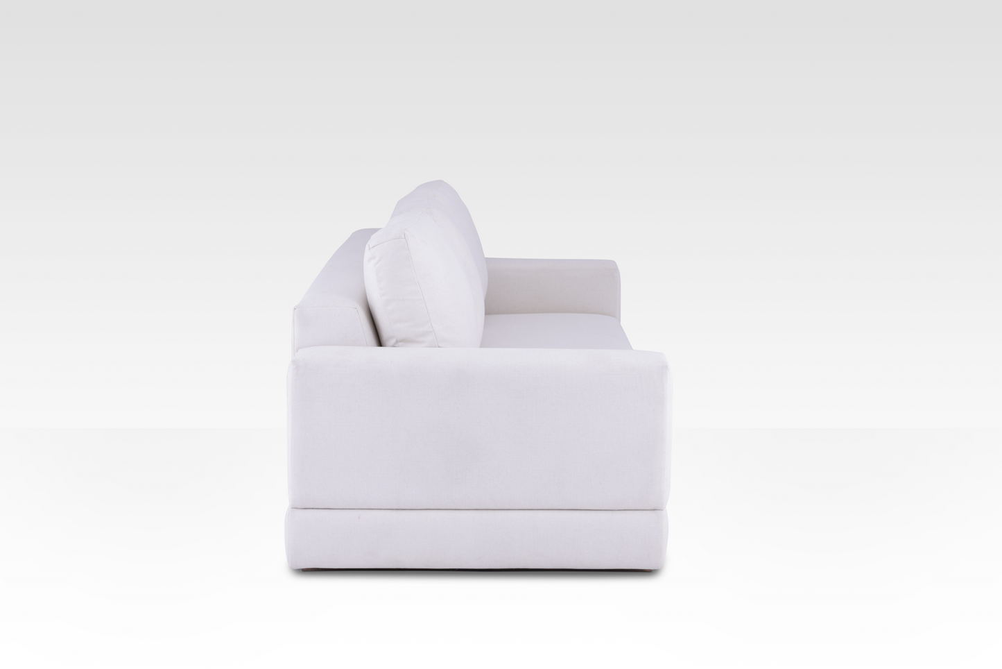 A side profile of the Vanilla Cream Kyra sofa, showing its deep seat and wide track arms.