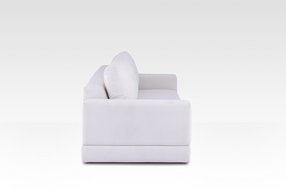 A side profile of the Vanilla Cream Kyra sofa, showing its deep seat and wide track arms.