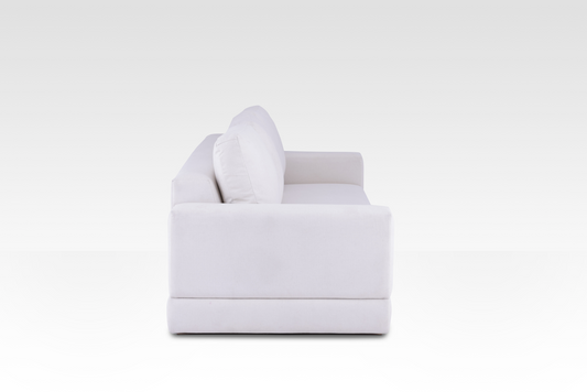 A side profile of the Vanilla Cream Kyra sofa, showing its deep seat and wide track arms.