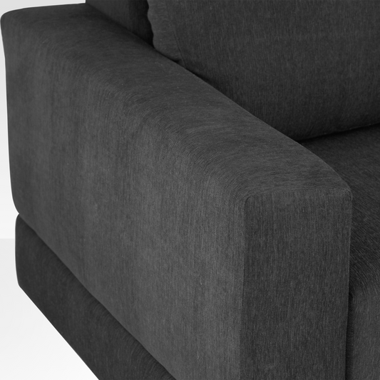 A close-up view of the Kyra sofa’s wide track arm and deep seat in Pewter gray textured fabric.