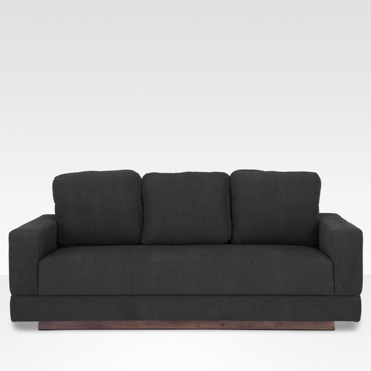 A straight-on view of the Kyra sofa in Pewter gray fabric, featuring a three-over-one cushion design and a solid wood platform base.