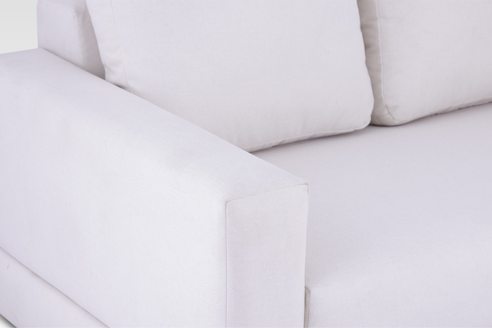 A macro detail view focusing on the wide track arm and the tight weave of the Vanilla Cream textured fabric.