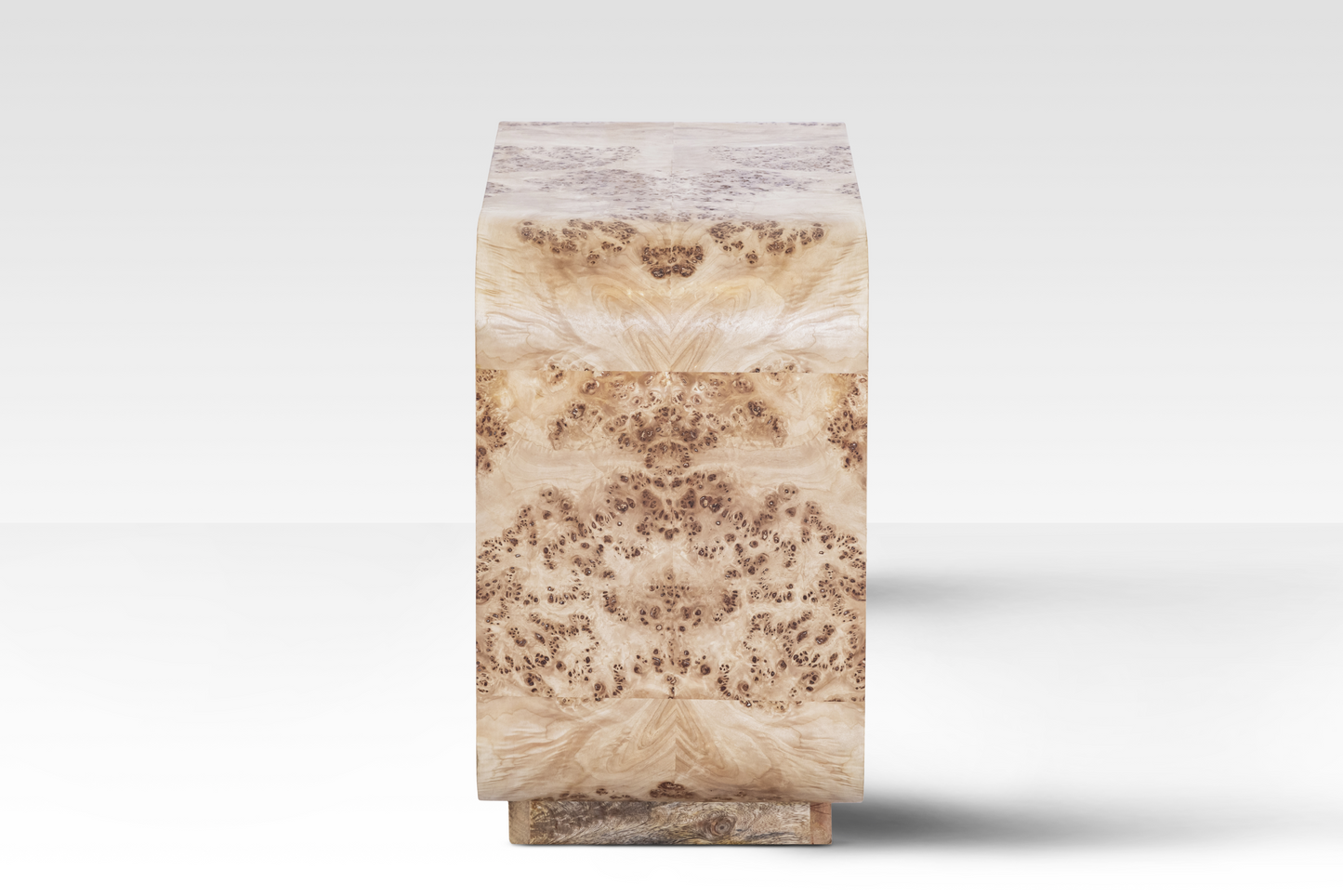 A side perspective of the Luca End Table showcasing the intricate swirling grain and natural 'eyes' of the rare Mappa Burl veneer.