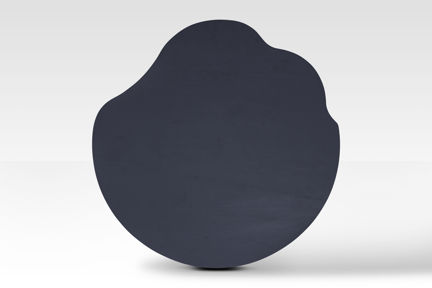Overhead view of the smaller Nook Nestled Coffee Table in matte black, showcasing its biomorphic silhouette and smooth, sophisticated finish.