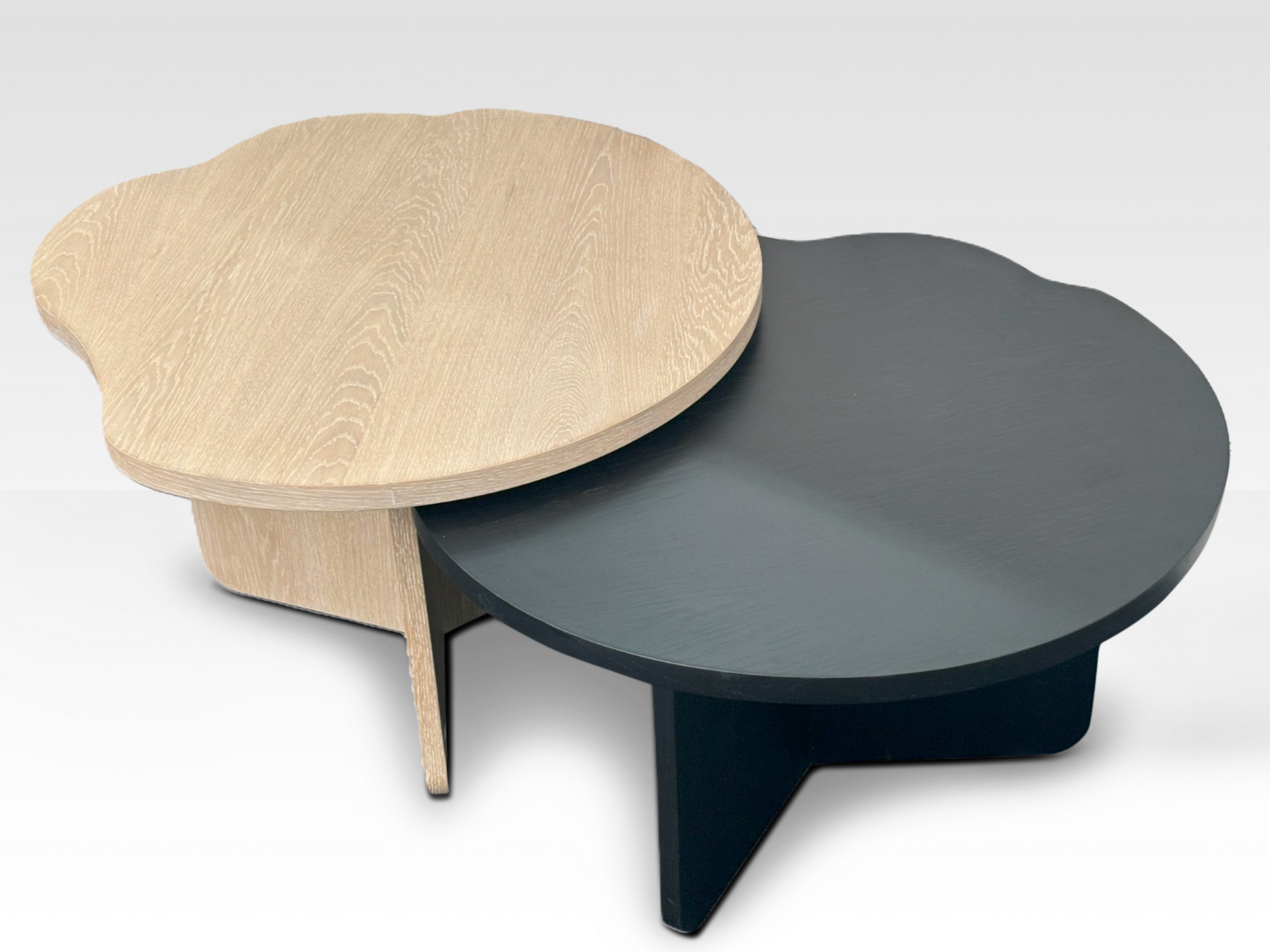 Overhead view of the oak and black nesting coffee tables highlighting the irregular wavy edges and organic design