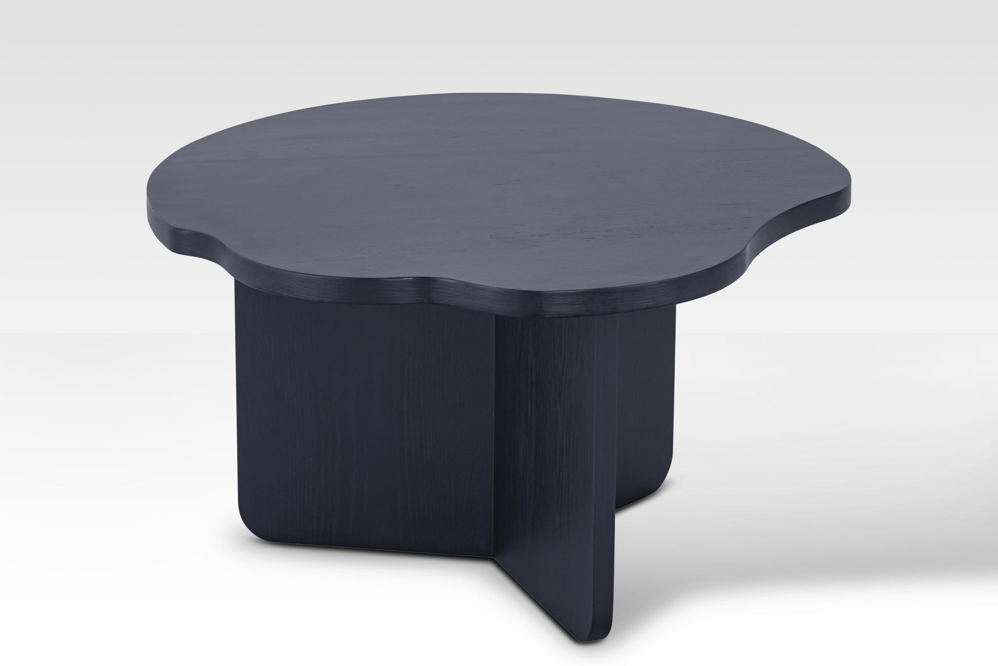 The individual Nook nestled table in matte black, showcasing the architectural tri-vane pedestal support and smooth finish.