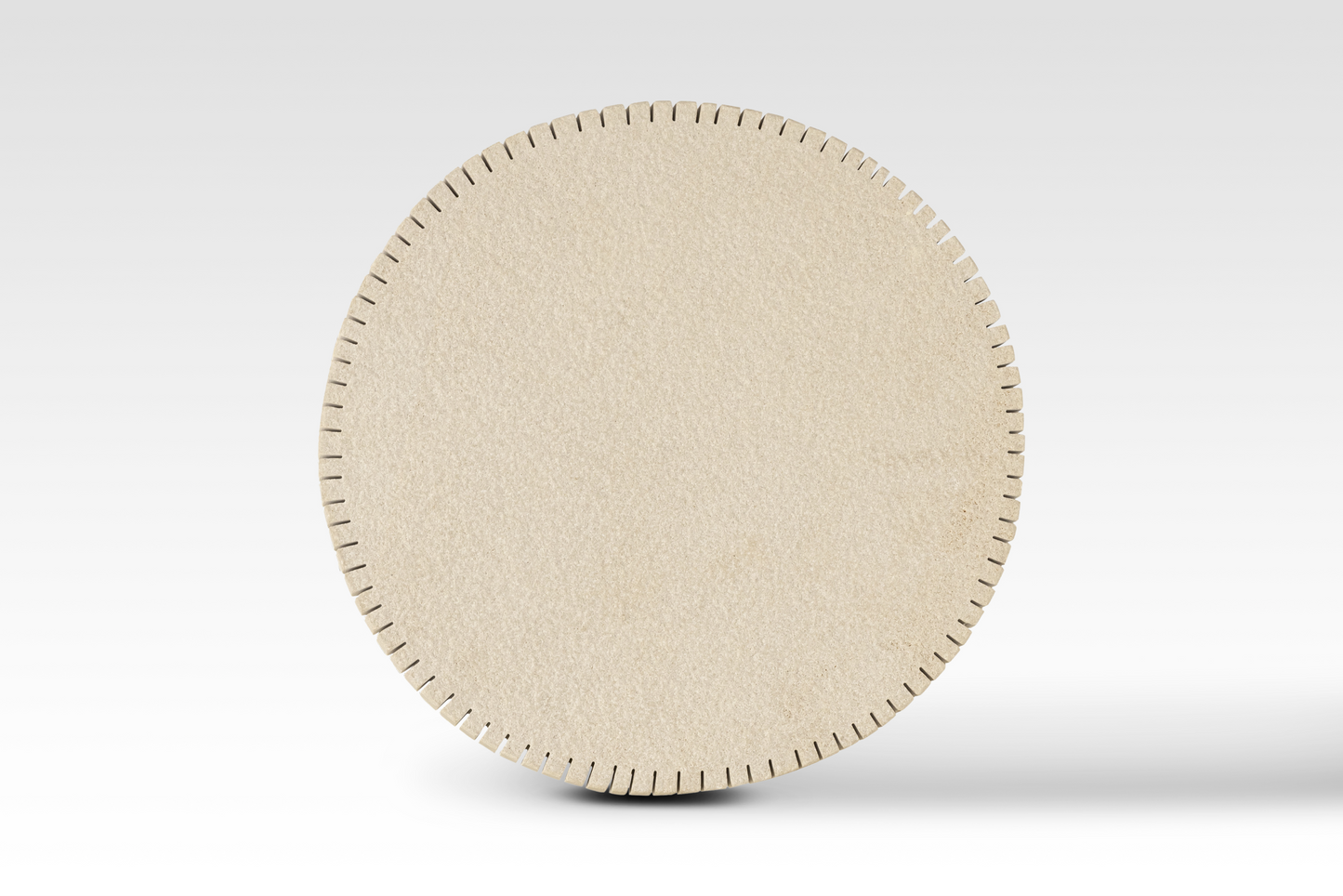 A perfectly circular overhead view of the Oasis End Table’s notched edge sandstone top, showcasing the architectural 'cog-style' perimeter and natural stone texture.