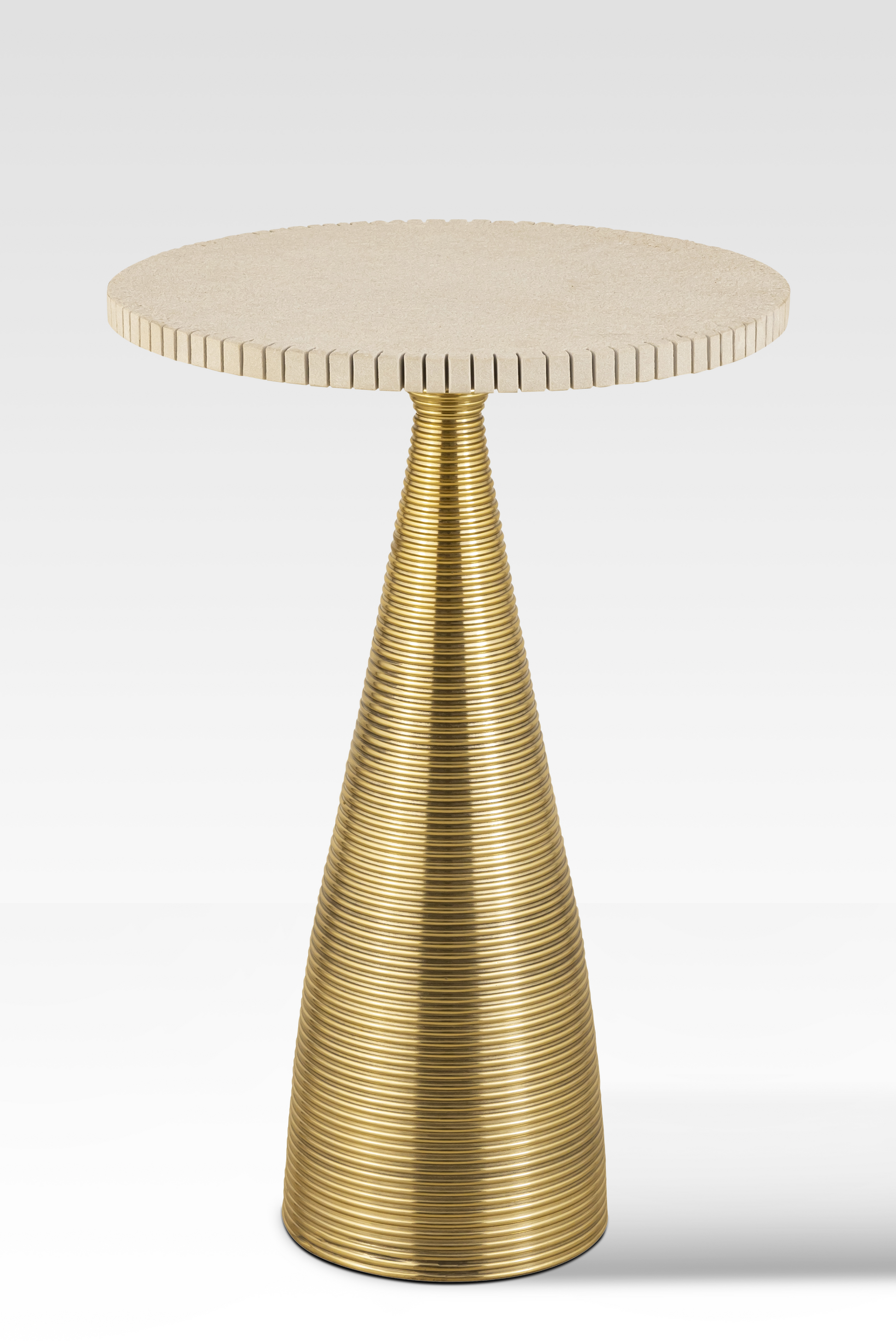 An angled view of the Oasis End Table featuring a notched natural sandstone top and a conical ribbed gold aluminum pedestal base.