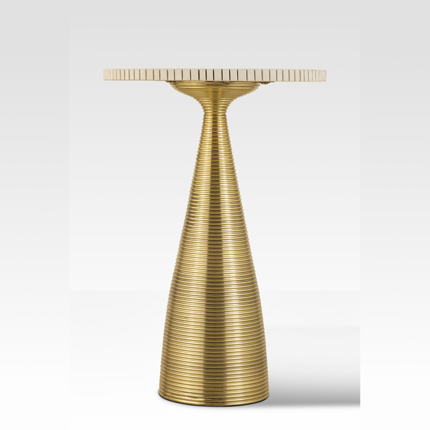 A straight-on profile of the Oasis End Table highlighting the tapered aluminum base and the precision-cut 'cog-edge' sandstone top.