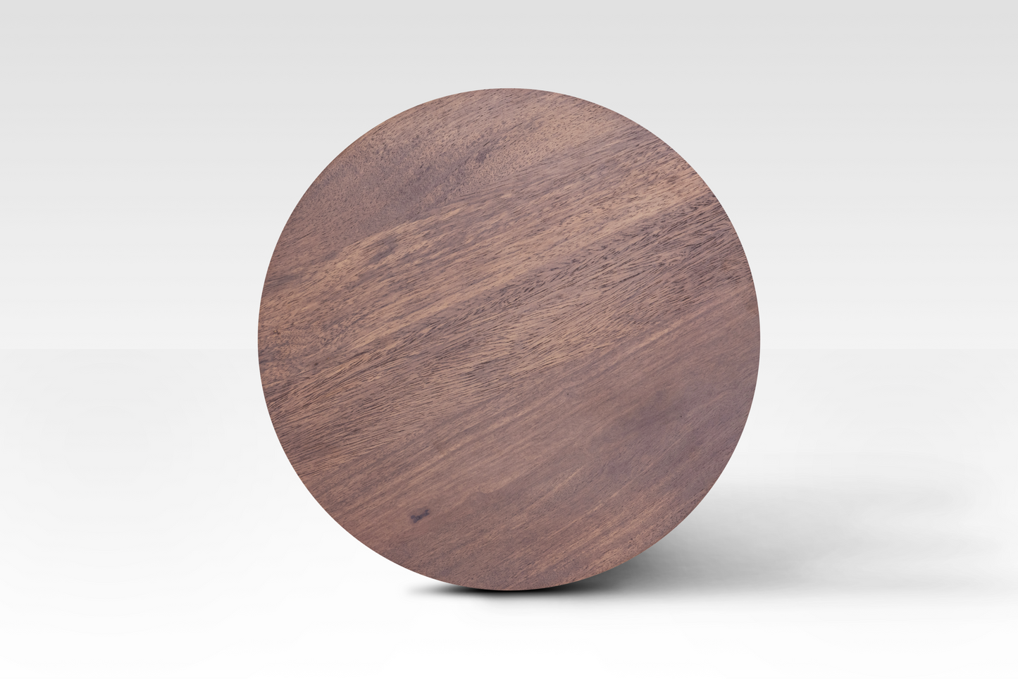 A perfectly circular overhead view of the Orbit End Table, showcasing the rich walnut finish and natural grain variations of the solid mango wood surface.