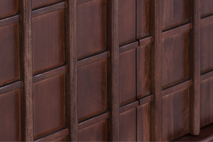 Macro shot of the geometric relief pattern and natural mango wood grain on the Quattro Sideboard door fronts.
