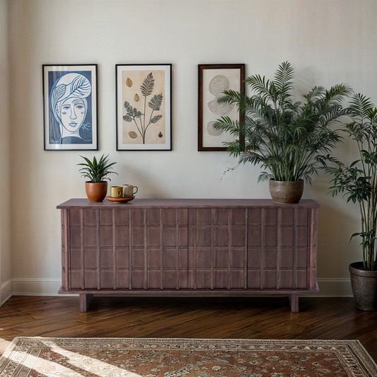 The dark wood Quattro Sideboard styled with lush indoor plants and a gallery wall of framed pictures, creating a sophisticated organic look.