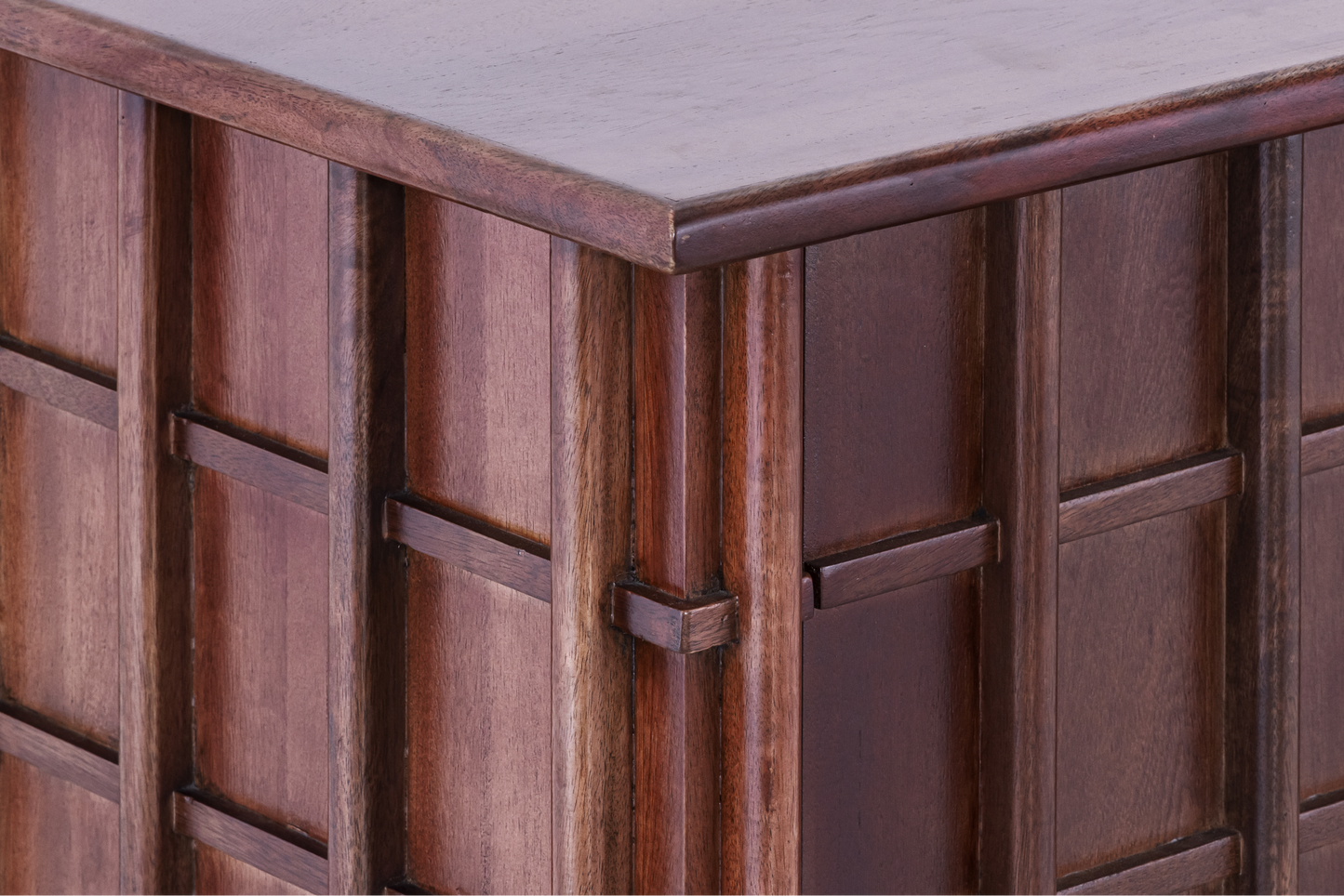Close-up of the masterfully crafted corner joints and the overlapping grid design on the Quattro storage console.